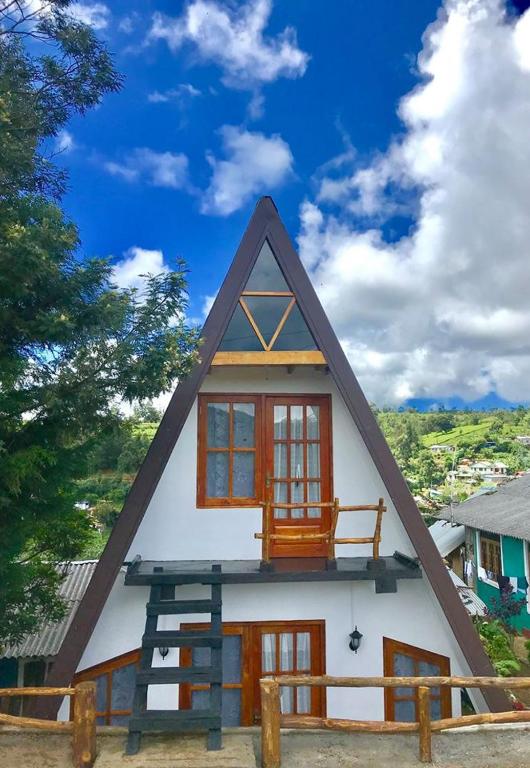 La Luna Cabins A-frame cabin under a misty Nuwara Eliya sky